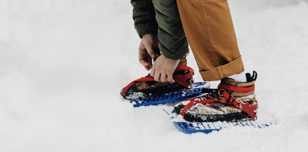 snowshoer tightening crampons 