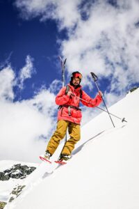 A backcountry skier wearing Snowfoot Snowshoes while traversing across a steep mountain slope in winter