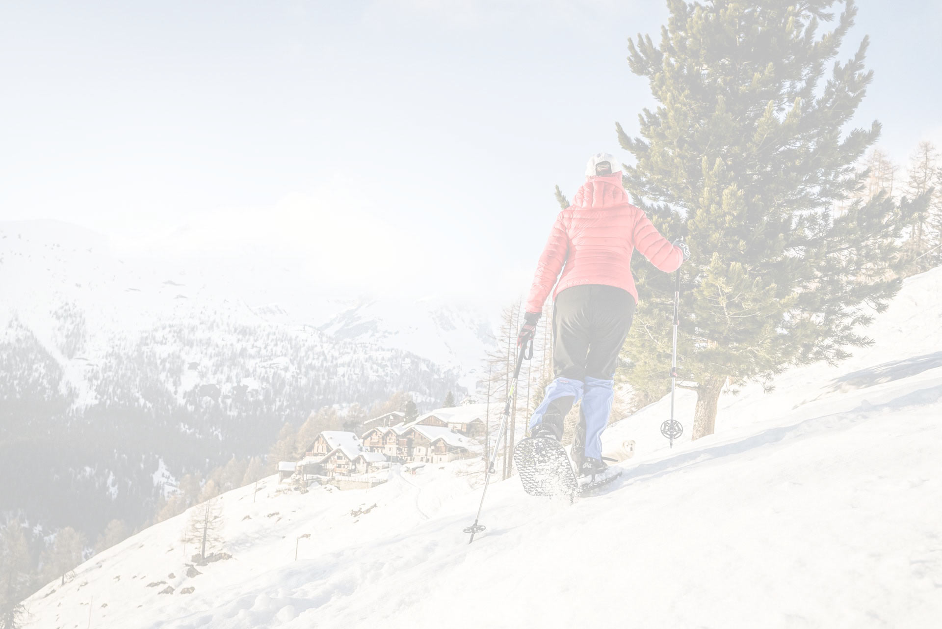 Woman snowshoeing through ice pack on mountainside during spring