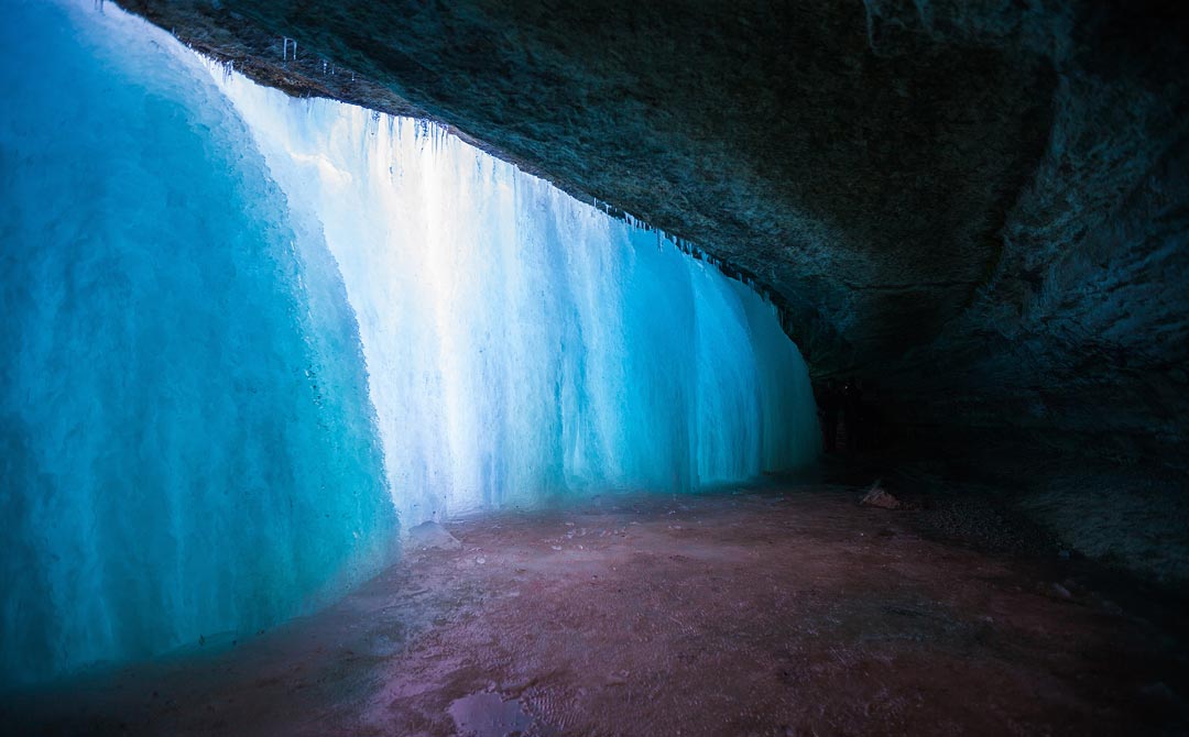A picture of the frozen Minnehaha Falls from behind