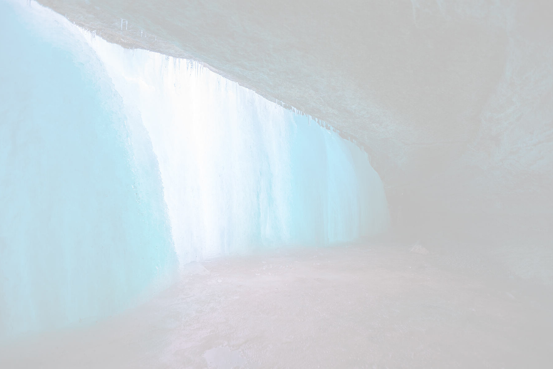 a view of frozen Minnehaha Falls in Minneapolis as someone walks behind the falls during winter