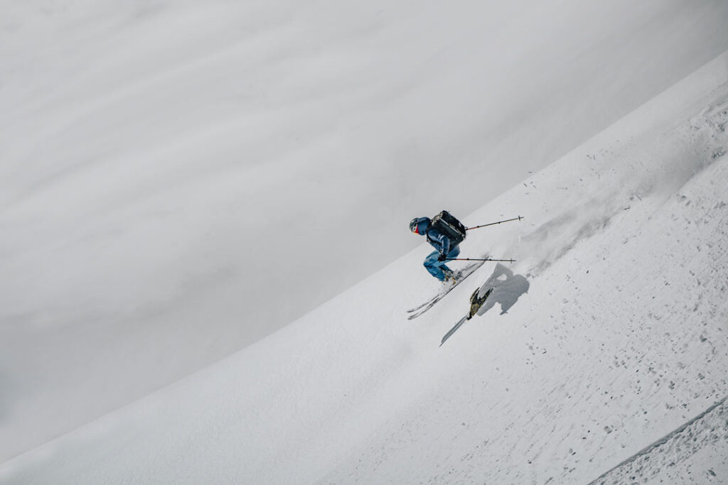 Backcountry skier making a jump on the downslope