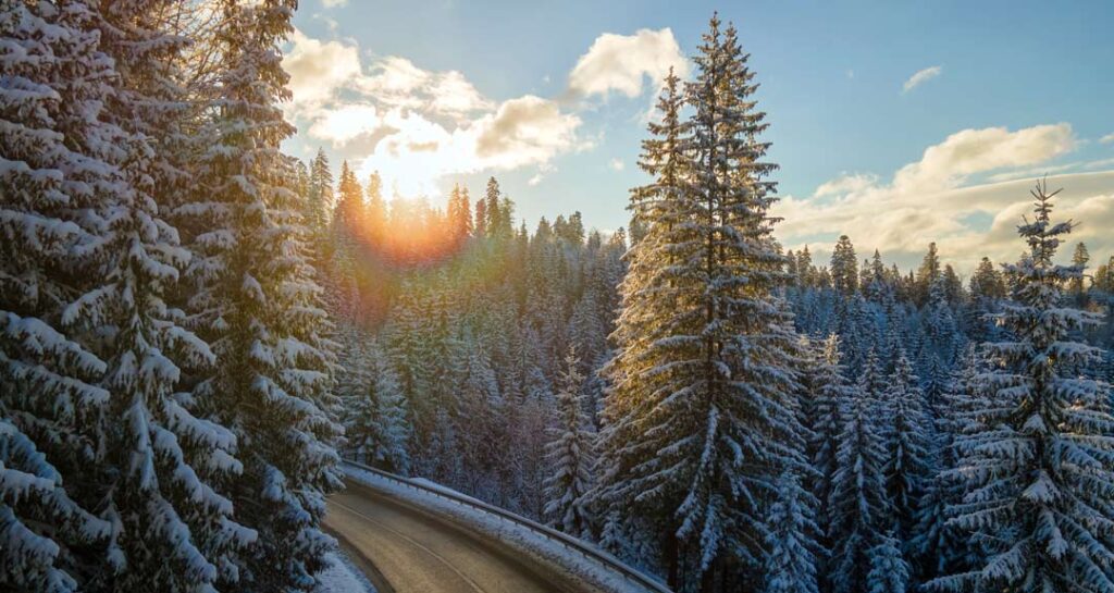 aerial view of a winding mountain road in winter